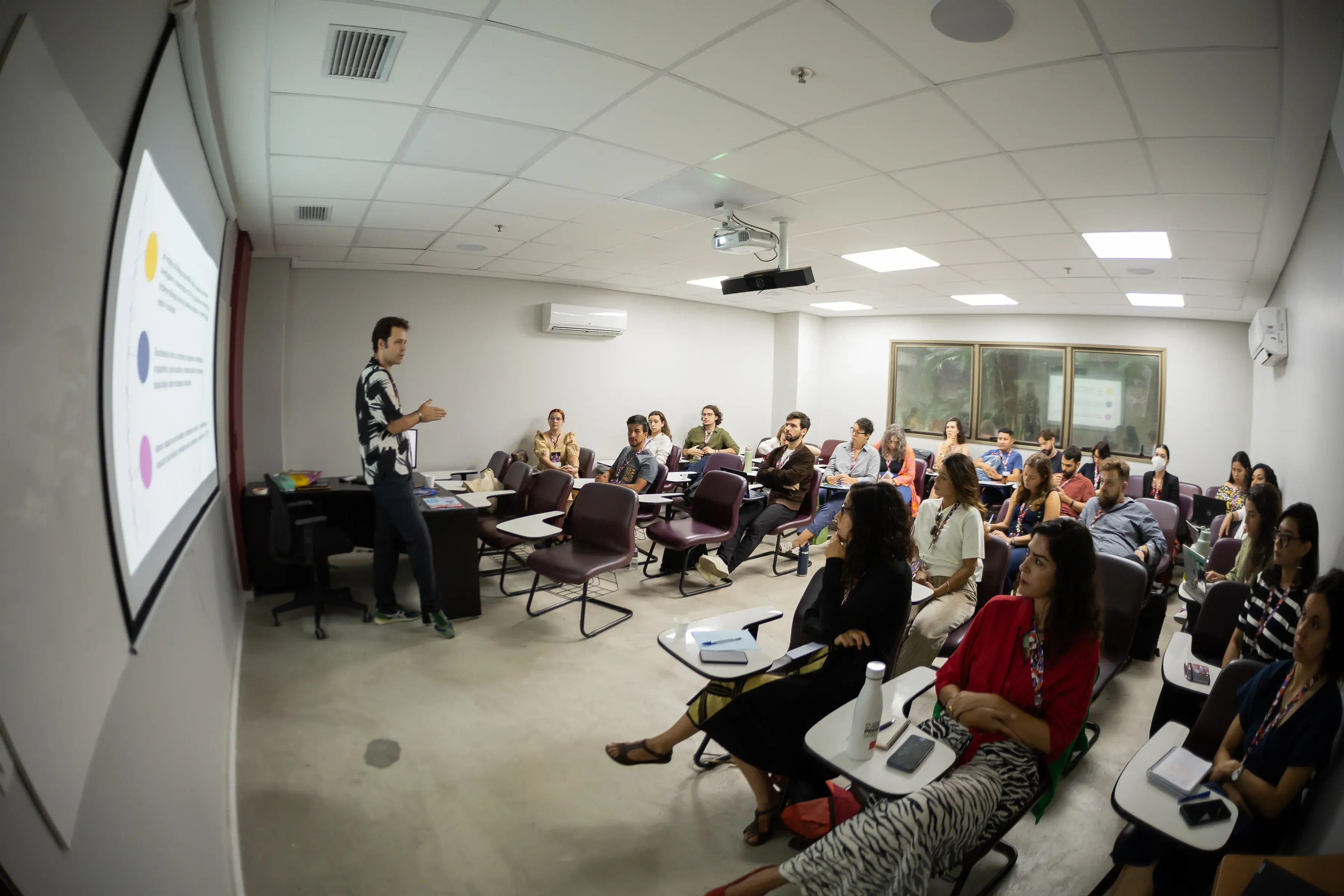 people gather in a classroom setting for a presentation